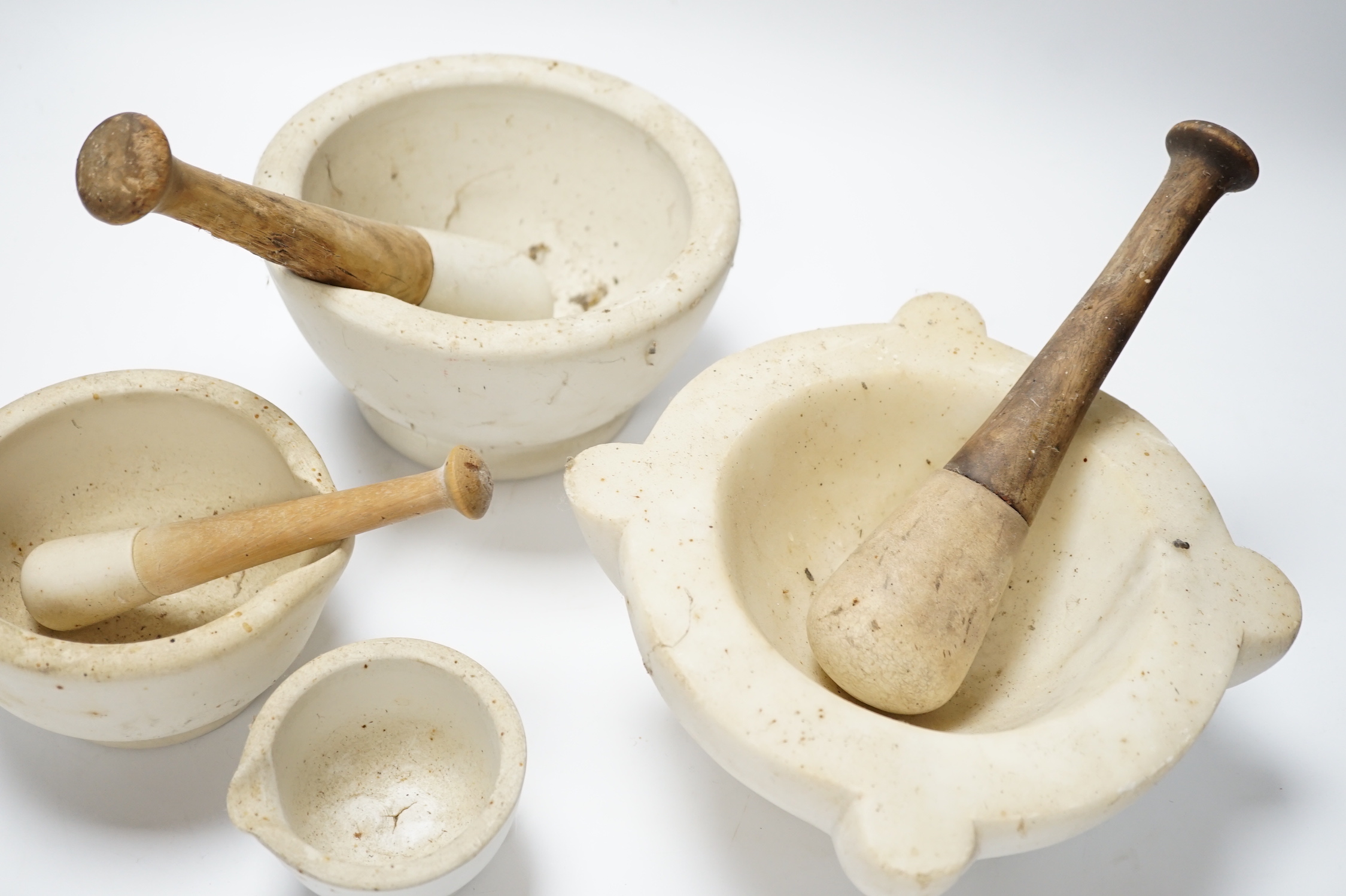 Four mortars and three pestles, largest 23cm wide